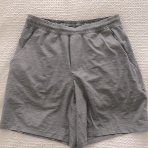 Men's Lululemon Grey Shorts. Spandex lined w/side pockets + extra zipped pocket.